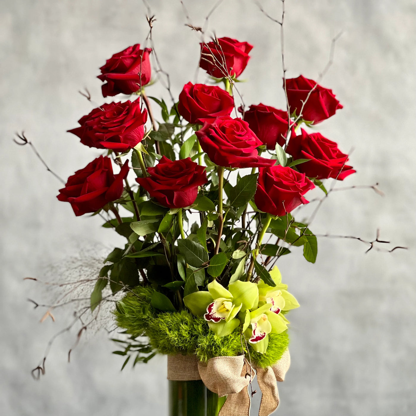 12 Roses Standing Tall arrangement with Ecuadorian long-stem roses and cymbidium orchids in a glass vase, available for same-day delivery by Beverly Hills Florist.