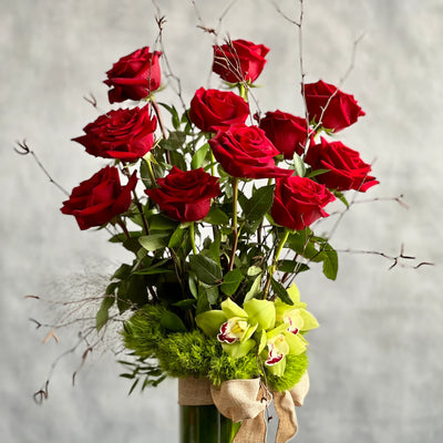 12 Roses Standing Tall arrangement with Ecuadorian long-stem roses and cymbidium orchids in a glass vase, available for same-day delivery by Beverly Hills Florist.