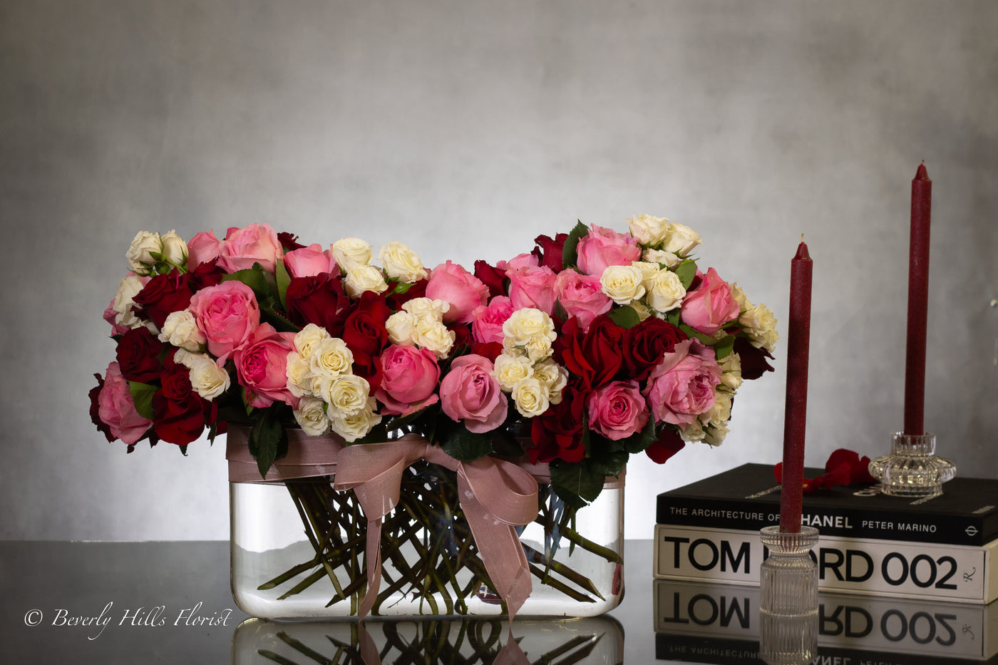 Luxury heart-shaped rose arrangement with over 100 premium red roses in a glass vase, available for same-day delivery in Beverly Hills and Los Angeles.