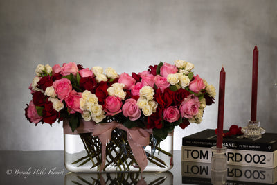 Luxury heart-shaped rose arrangement with over 100 premium red roses in a glass vase, available for same-day delivery in Beverly Hills and Los Angeles.