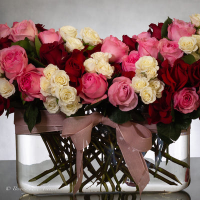 Luxury heart-shaped rose arrangement with over 100 premium red roses in a glass vase, available for same-day delivery in Beverly Hills and Los Angeles.