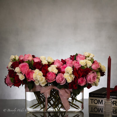 Luxury heart-shaped rose arrangement with over 100 premium red roses in a glass vase, available for same-day delivery in Beverly Hills and Los Angeles.