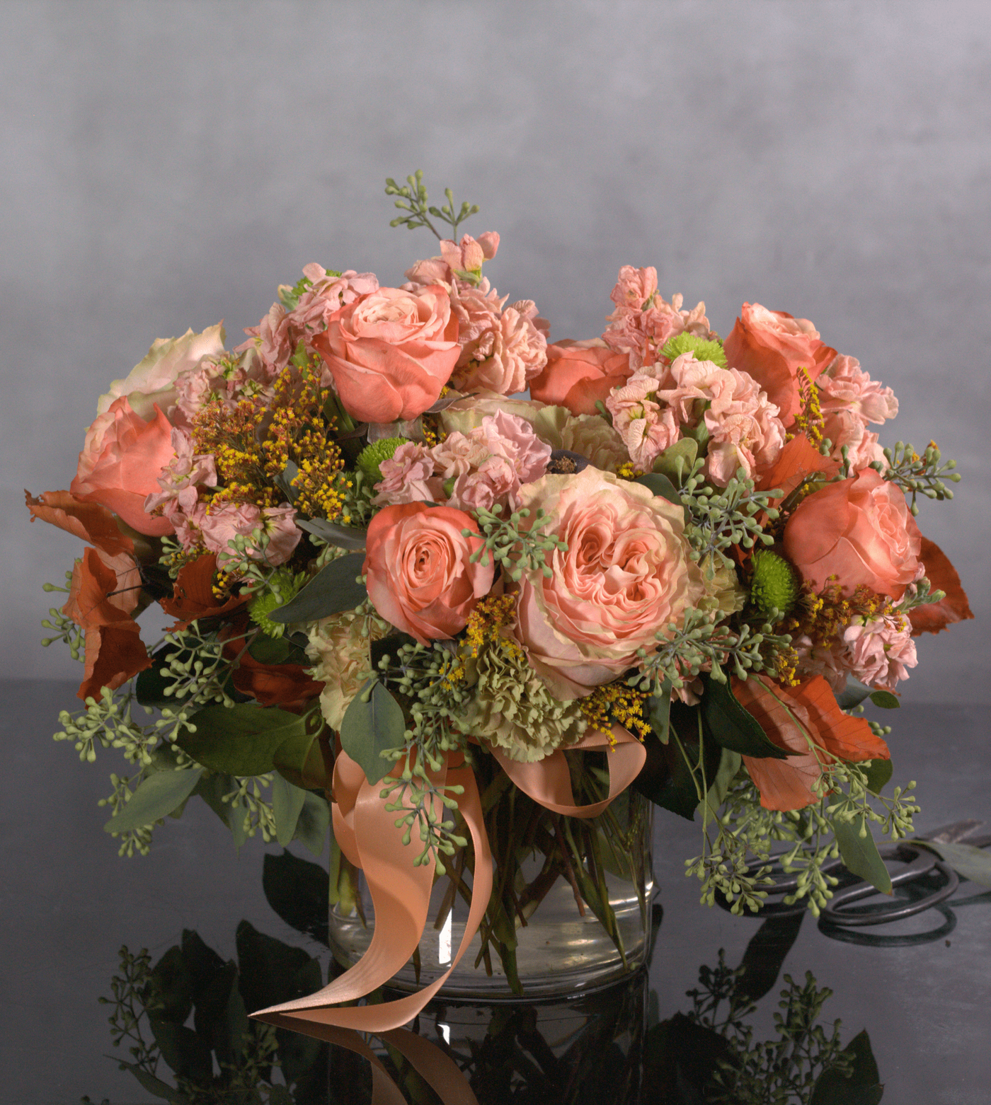 This exquisite arrangement captures the essence of fall romance, Beverly Hills style. Delicate peach garden roses, symbolizing gratitude and appreciation, are artfully paired with airy seeded eucalyptus, creating a sense of effortless beauty. Perfect for any special occasion or a luxurious touch to your home.