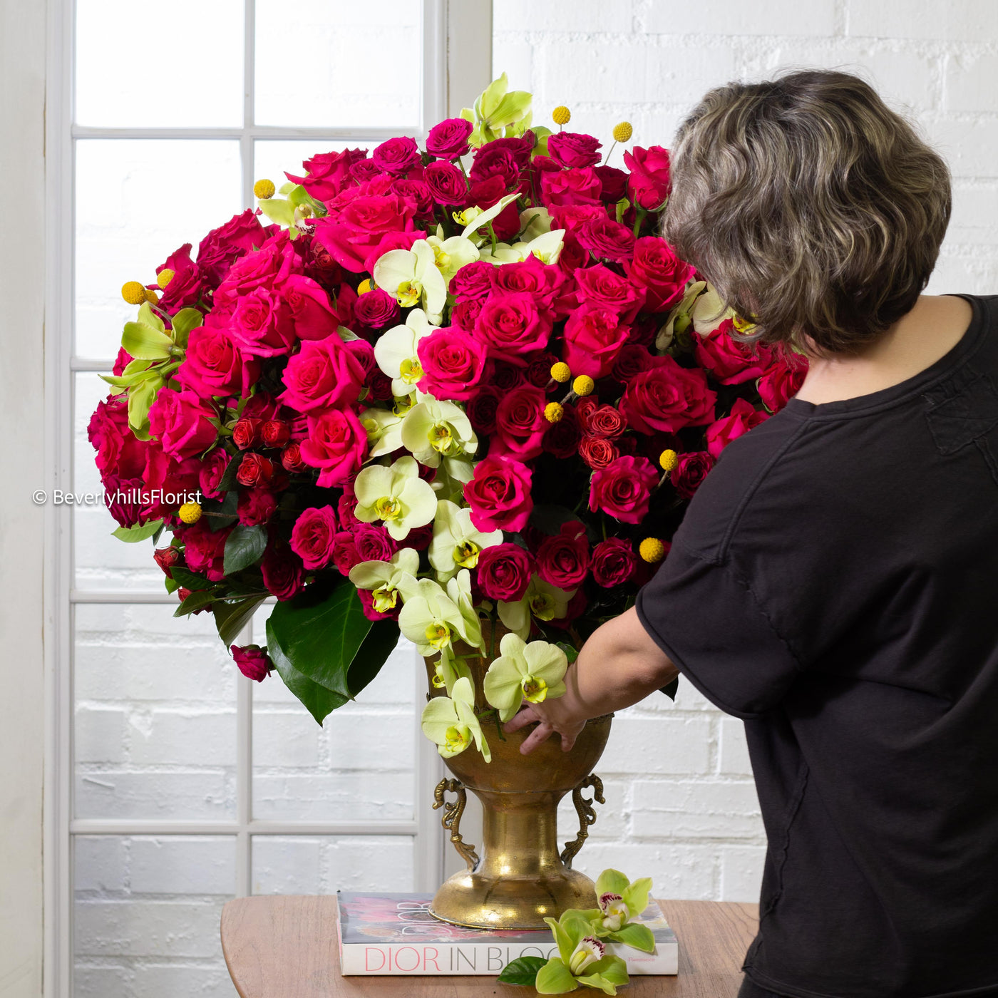 Amore Roses arrangement with red, pink, and cream roses, orchids, and spray roses in a golden pedestal container, available for same-day delivery by Beverly Hills Florist.