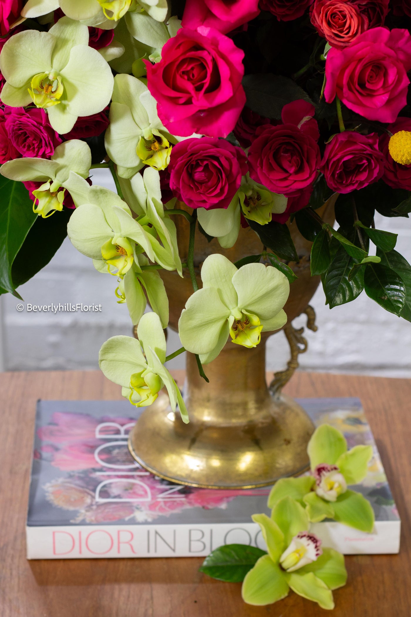 Amore Roses arrangement with red, pink, and cream roses, orchids, and spray roses in a golden pedestal container, available for same-day delivery by Beverly Hills Florist.