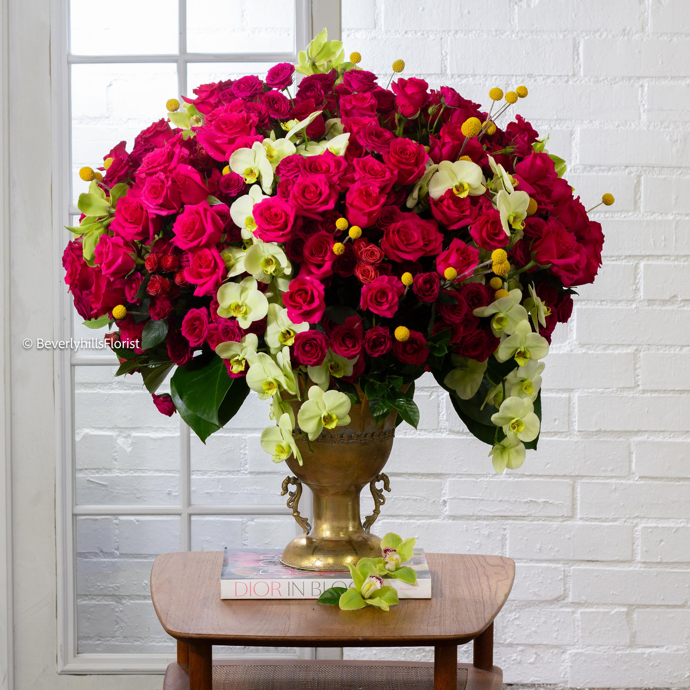 Amore Roses arrangement with red, pink, and cream roses, orchids, and spray roses in a golden pedestal container, available for same-day delivery by Beverly Hills Florist.