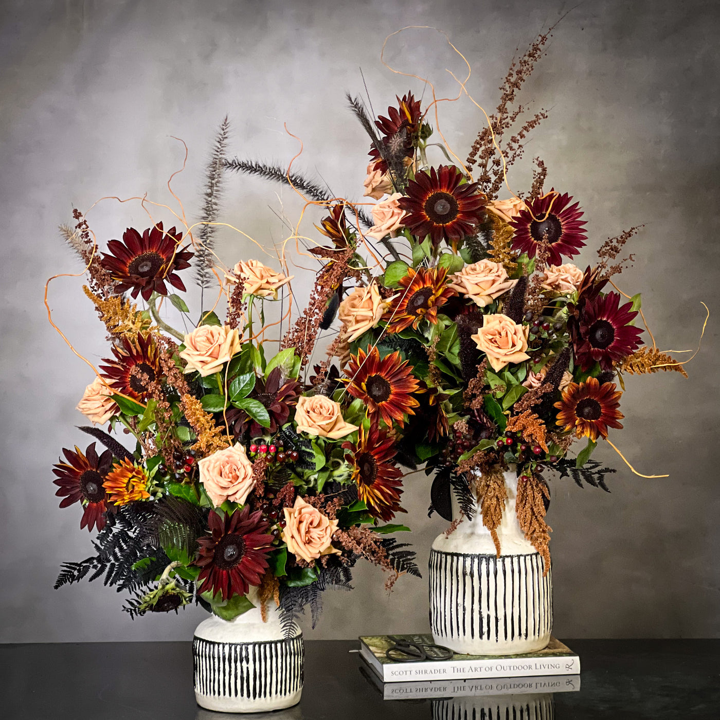 Black Sun arrangement featuring bold sunflowers in a white ceramic vase with black lines, available for same-day delivery by Beverly Hills Florist.