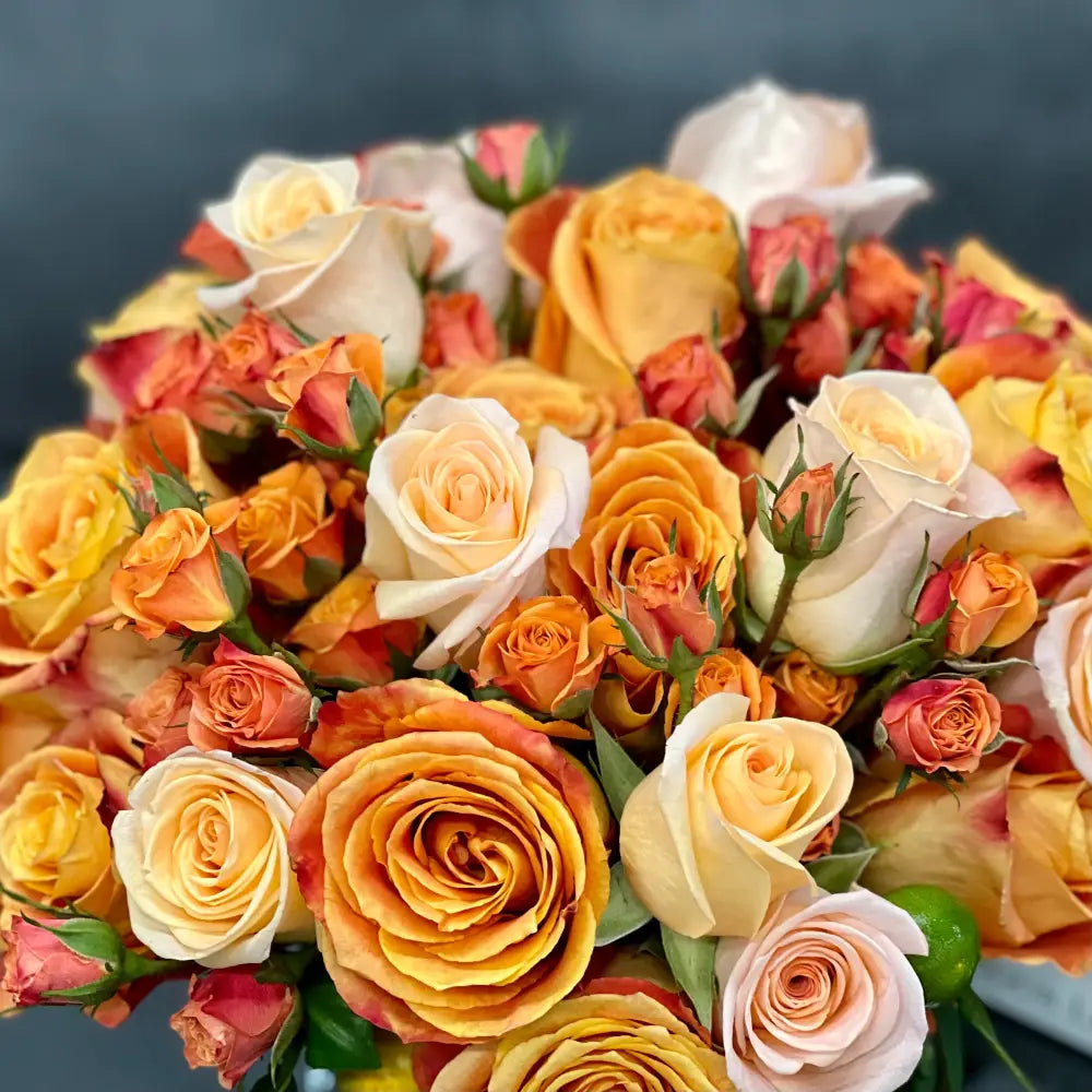 Blooms of Sunshine - Elegant Citrus Delight arrangement featuring vibrant flowers in a handcrafted 11-inch round design, perfect for brightening any space.