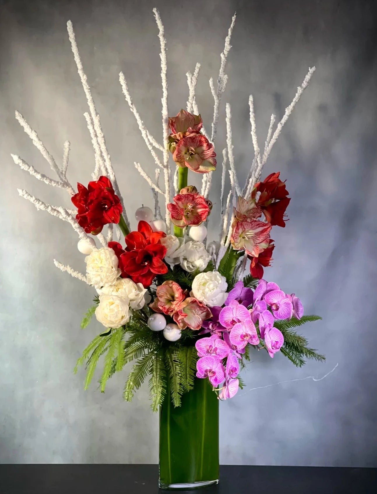 Branch Away grand centerpiece with peonies, amaryllis, and phalaenopsis orchids, available for same-day delivery by Beverly Hills Florist.