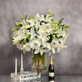 Tall long stem Casablanca lilies arranged in a glass vase with same-day delivery in Beverly Hills