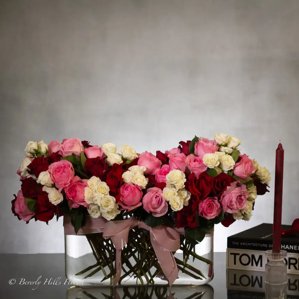 Luxury heart-shaped rose arrangement with over 100 premium red roses in a glass vase, available for same-day delivery in Beverly Hills and Los Angeles.