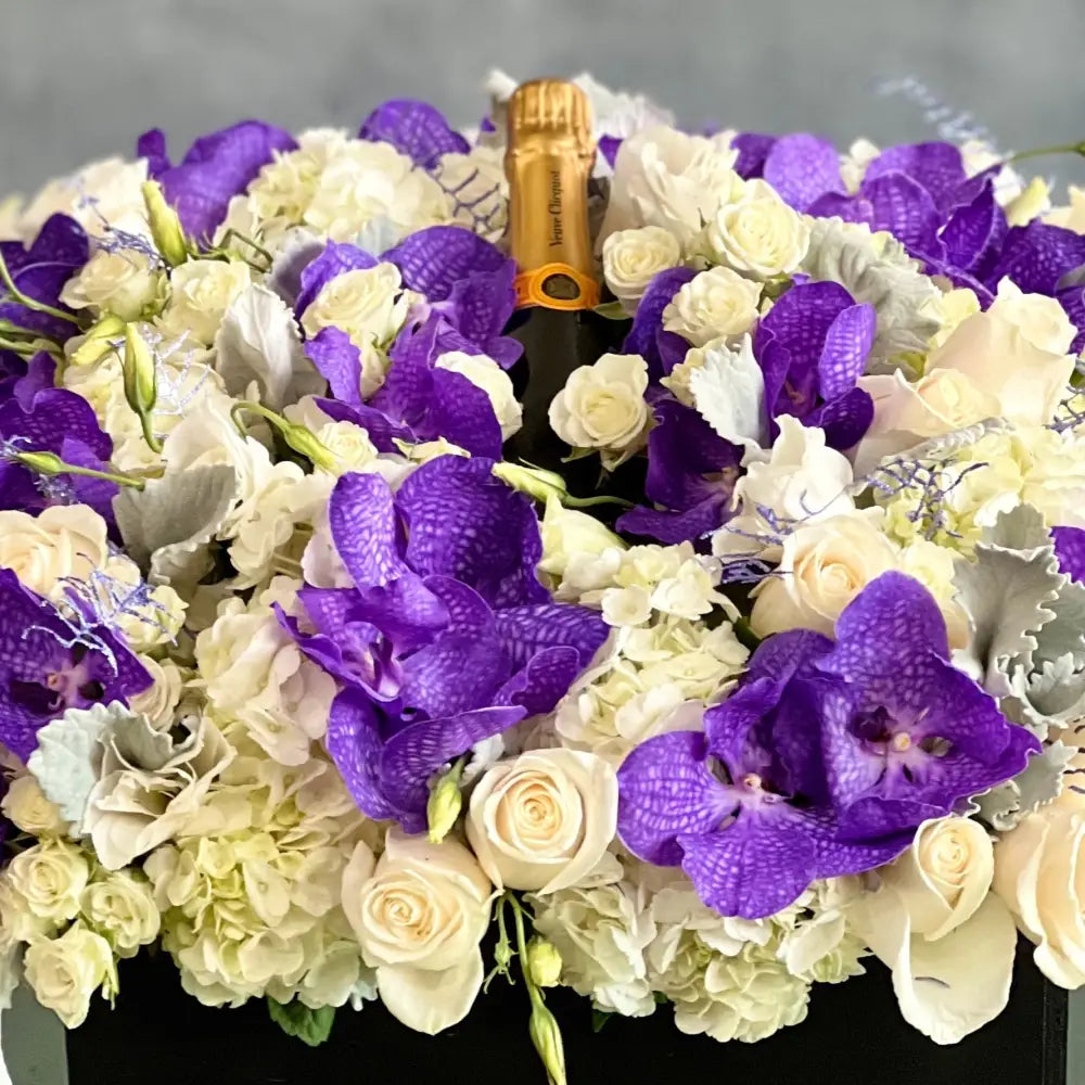 Luxury square flower box with white roses, purple and white Vanda orchids, and Veuve Clicquot champagne by Beverly Hills Florist