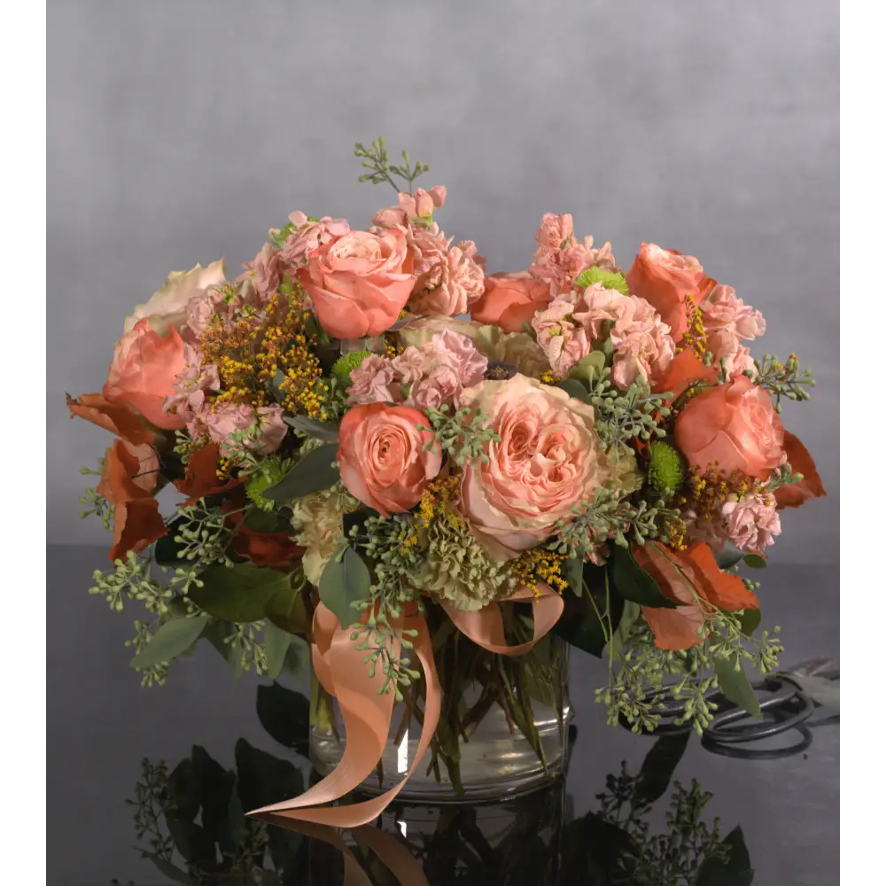 This exquisite arrangement captures the essence of fall romance, Beverly Hills style. Delicate peach garden roses, symbolizing gratitude and appreciation, are artfully paired with airy seeded eucalyptus, creating a sense of effortless beauty. Perfect for any special occasion or a luxurious touch to your home.