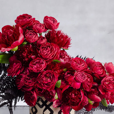 Peony Romance - beverlyhillsfloristPeony Romance floral arrangement with red garden spray roses and burgundy peonies in a ceramic vase, 18 inches tall, available for same-day delivery by Beverly Hills Florist.