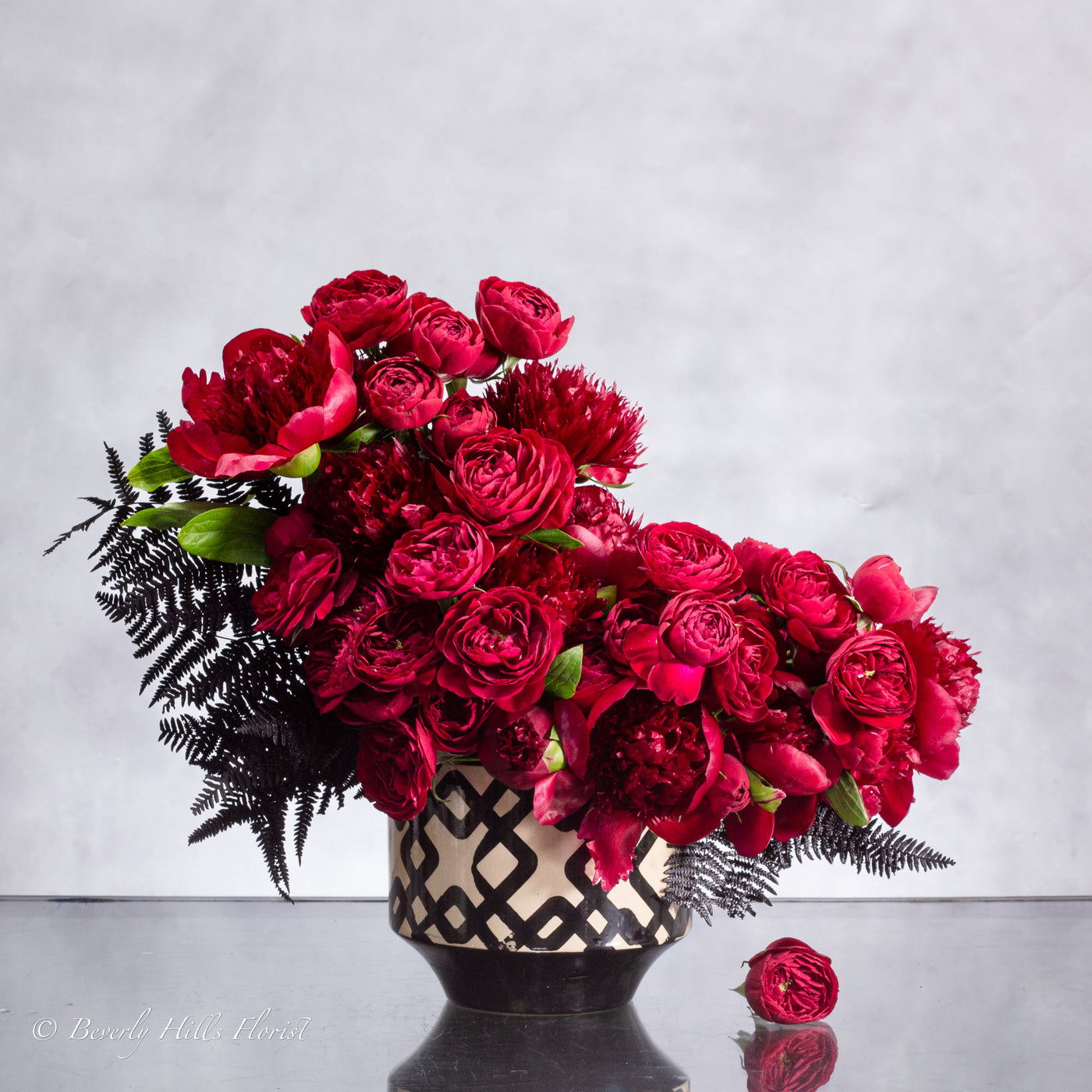 Peony Romance floral arrangement with red garden spray roses and burgundy peonies in a ceramic vase, 18 inches tall, available for same-day delivery by Beverly Hills Florist.