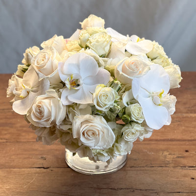 Elegant white roses and orchids arrangement in a glass vase, Beverly Hills Florist.