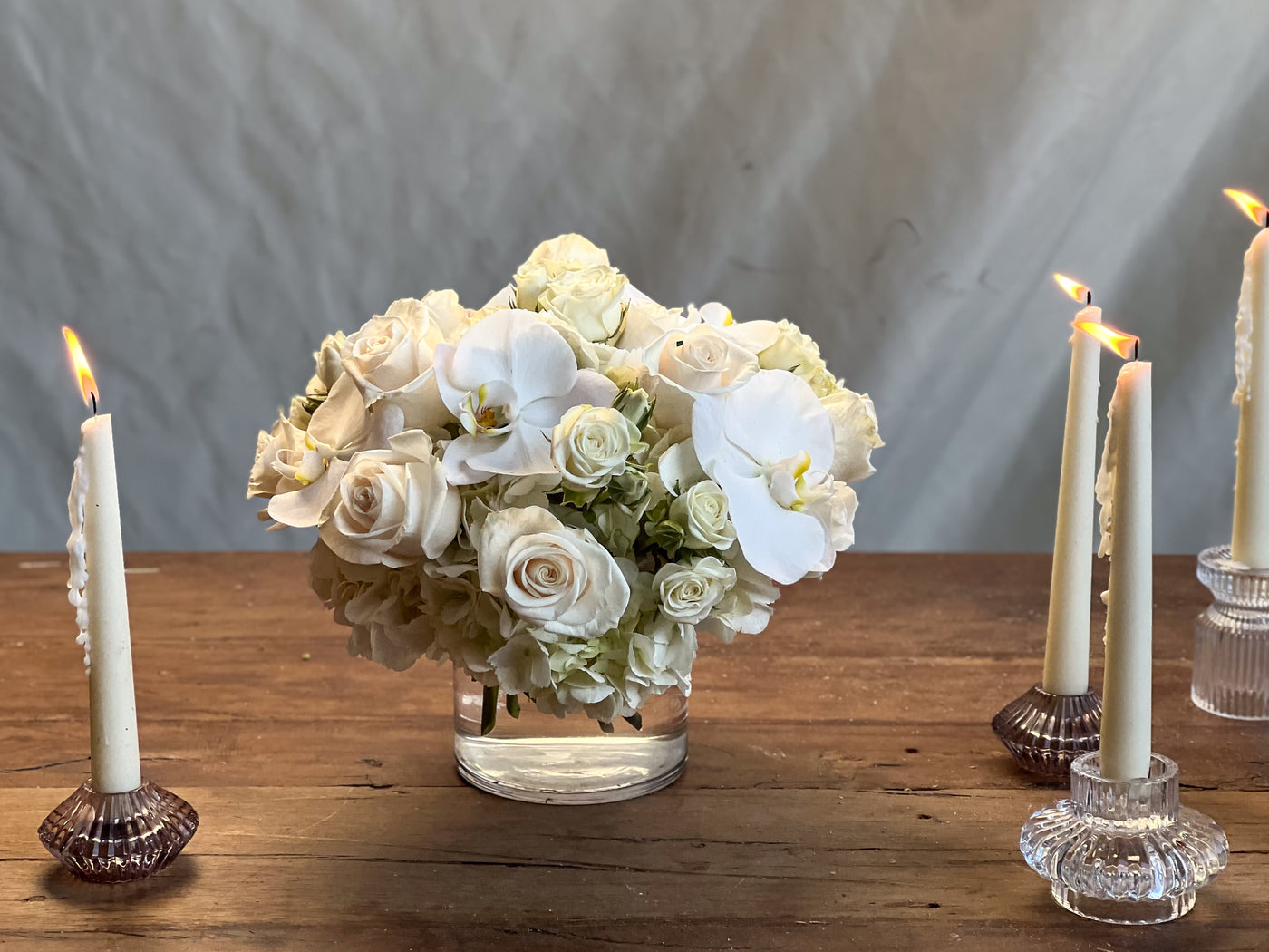 Elegant white roses and orchids arrangement in a glass vase, Beverly Hills Florist.