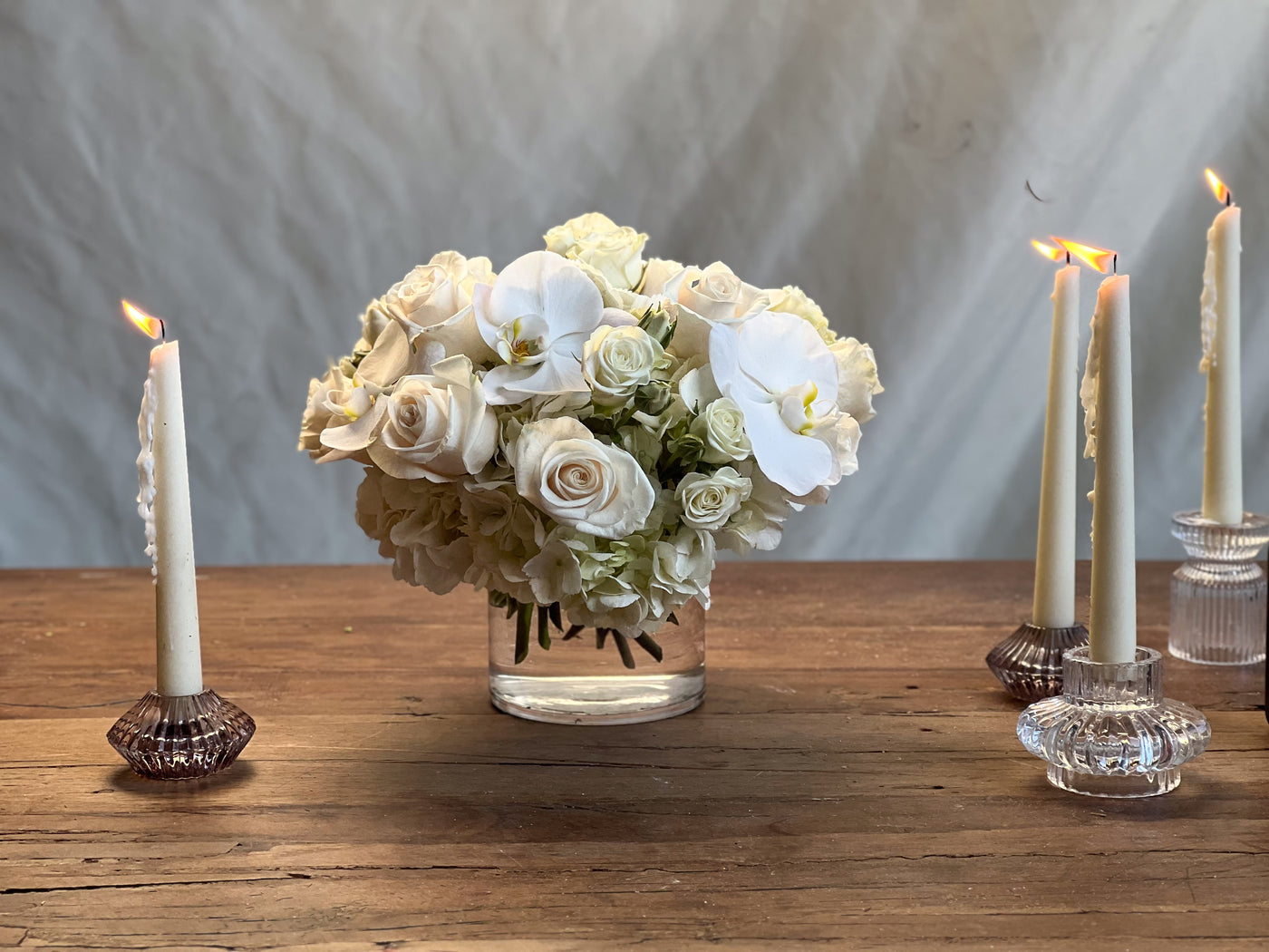 Elegant white roses and orchids arrangement in a glass vase, Beverly Hills Florist.