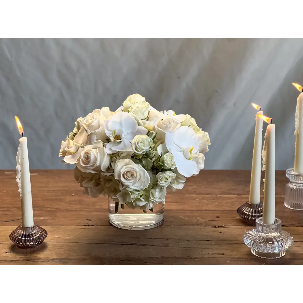 Elegant white roses and orchids arrangement in a glass vase, Beverly Hills Florist.