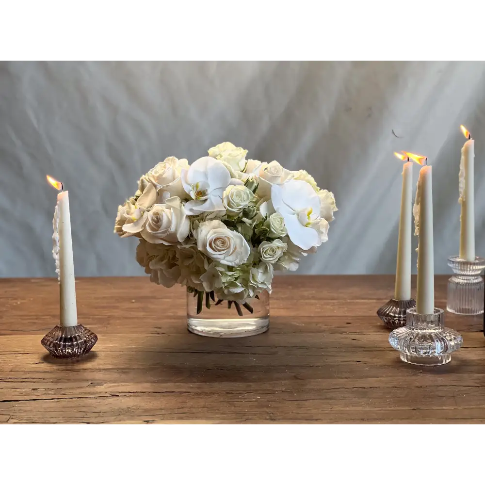 Elegant white roses and orchids arrangement in a glass vase, Beverly Hills Florist.