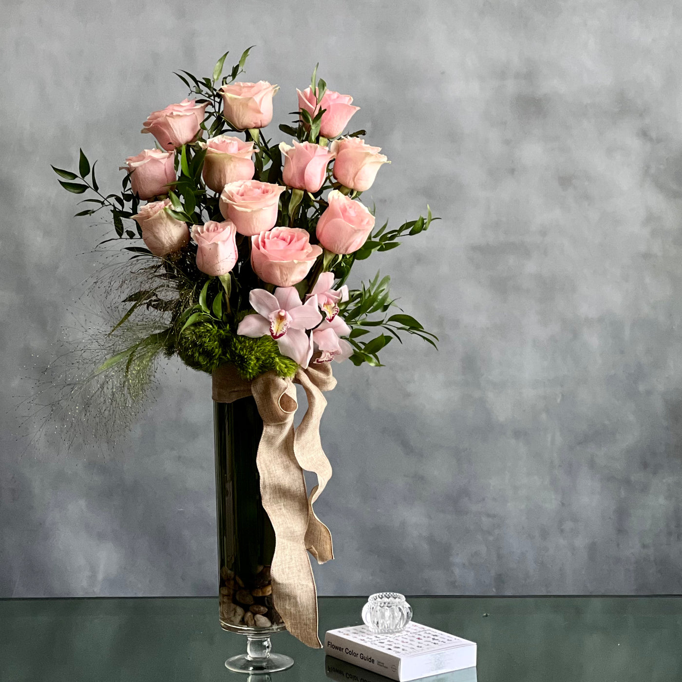 12 Pink Long Stem Roses Standing Tall arrangement with Ecuadorian long-stem roses and cymbidium orchids in a glass vase, available for same-day delivery by Beverly Hills Florist.