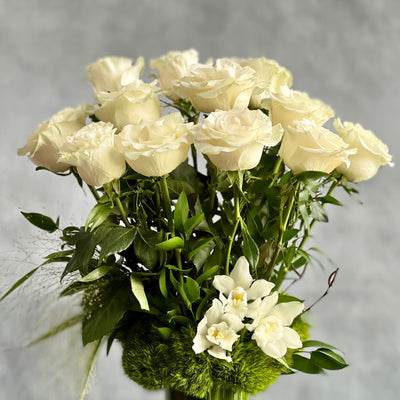 12 White Long Stem Roses Standing Tall arrangement with Ecuadorian long-stem roses and cymbidium orchids in a glass vase, available for same-day delivery by Beverly Hills Florist.