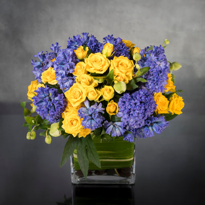 Summer Solstice features yellow spray Roses and purple Hyacinths, and seasonal flowers in a leaf-lined glass vase. This sweet, summery arrangement will bring a ray of sunshine to anyone's day. Beverly Hills Florist offers same day delivery for our summer solstice ! Blooms maybe replaced depending on the season. Perfect for the summer, thank you, thinking of you and birthday flowers! 