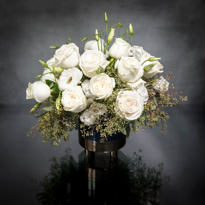 Beverly Hills Florist presents this is a beautiful marriage of two varieties of flowers for same day delivery ... Lisianthus  and Roses nested on seasonal greens in a blue and gold footed vase. Birthday flowers, Thank you flowers, Thinking of you flowers and get well soon flowers. 