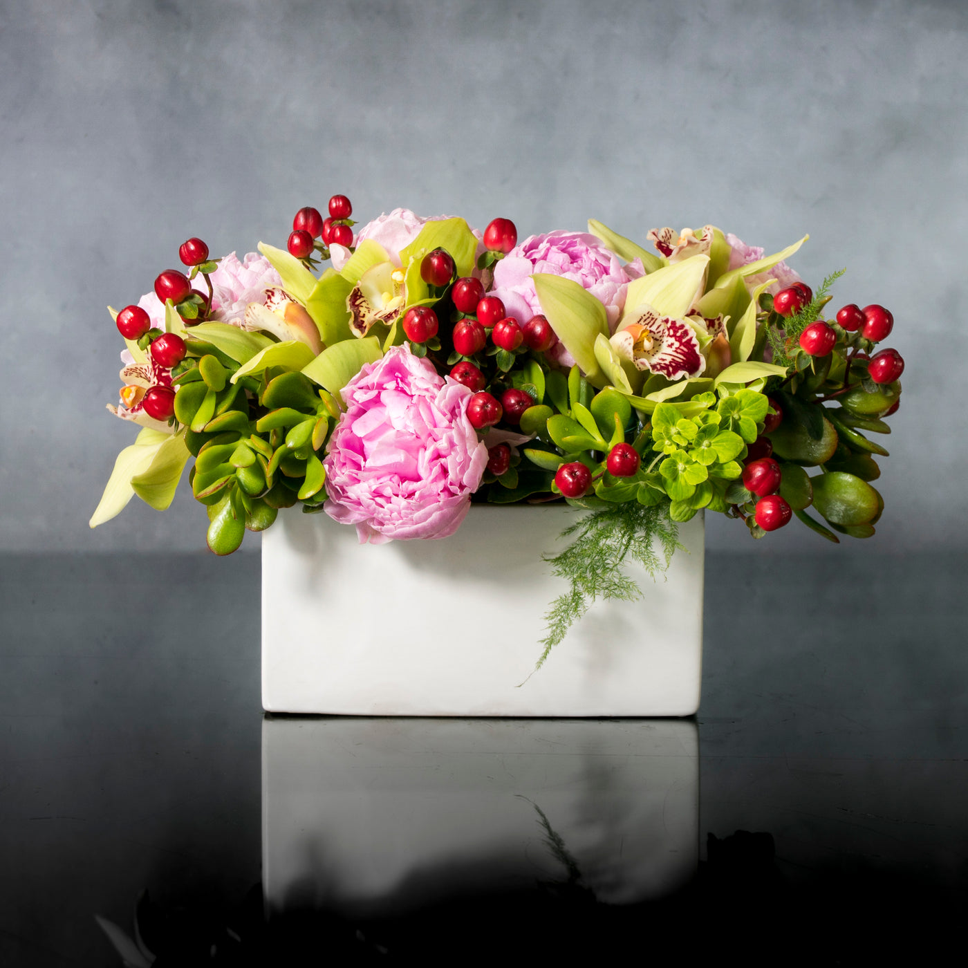 Beverly Hills Florist presents a beautiful arrangement for same day delivery. In this piece we have pink Peonies, Berries and Seasonal greens accented with green Cymbidium Orchids. Made for a birthday, office decor or a welcome home. 