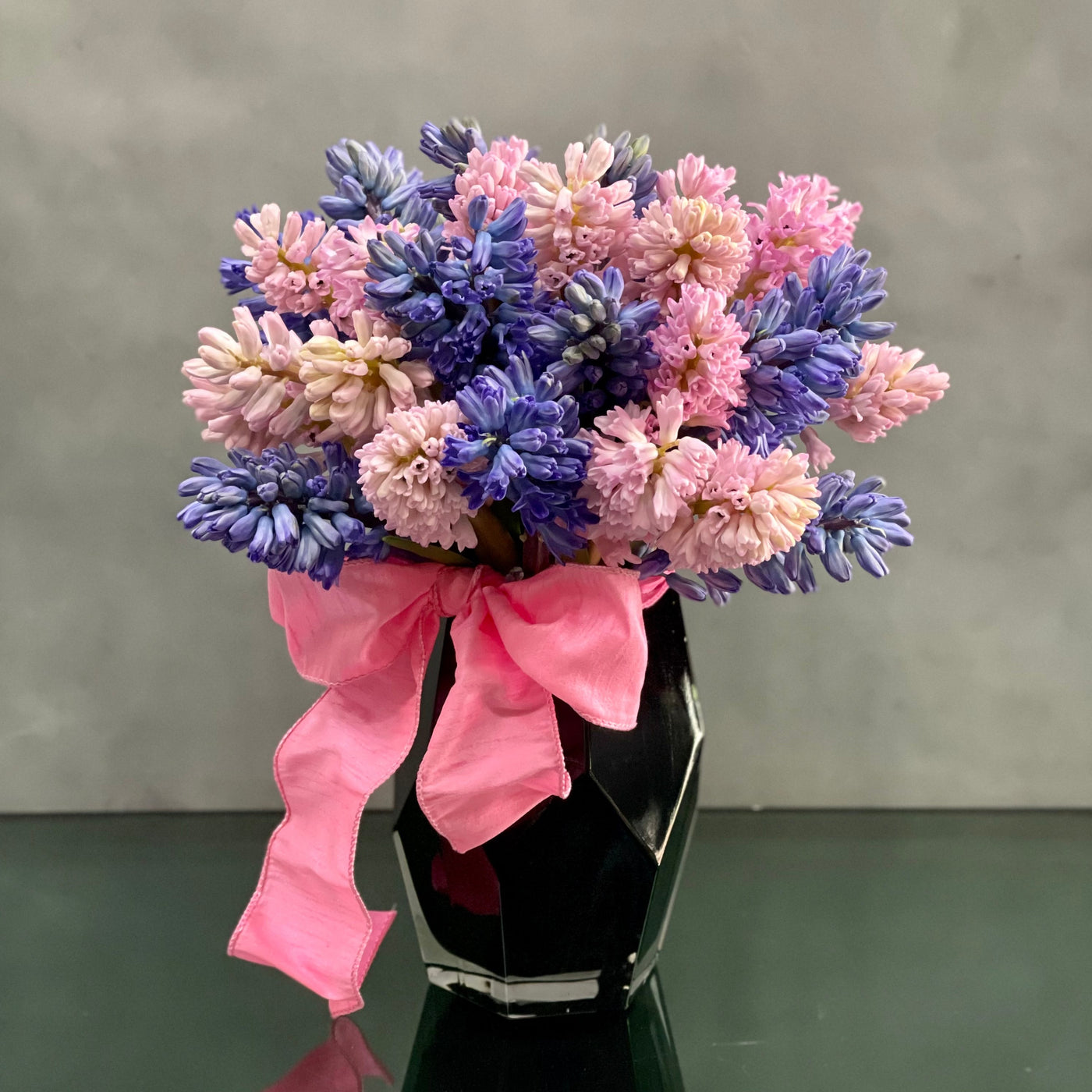 Bold and Beautiful, Beverly Hills Florist presents Hiya for same day delivery ! Enjoy the sweet smell of 30 colorful hyacinths in a black geometric medium vase.   Substitutions available upon request. Standard shown. Birthday, Thank you, Thinking of you, welcome baby, welcome flowers