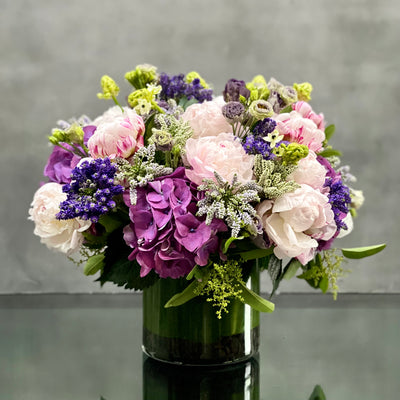 This luxurious and soft bouquet of pale Peonies and lavender and purple colored imported seasonal flowers presented in a glass vase. Beverly hills Florist presents our Hearts of Spring arrangement for same day delivery! A beautiful touch of seasonal blooms for any occasion! Birthday Flowers, Office flowers, Thank you flowers