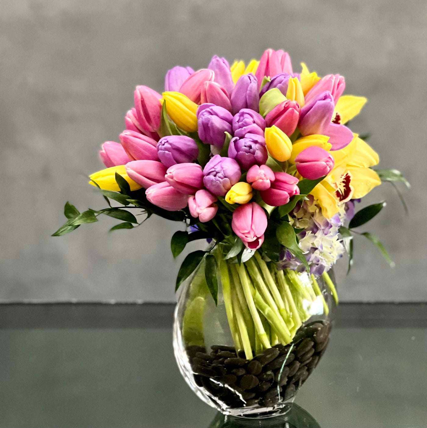 Here's a spring-tastic way to brighten someone's day from Beverly Hills Florist. With our same day delivery arrangement placed in a glass vase of beautiful Tulips, Orchids and Hydrangeas, it makes a delightful decoration for a table, or any corner of the home office that could use a little magic.