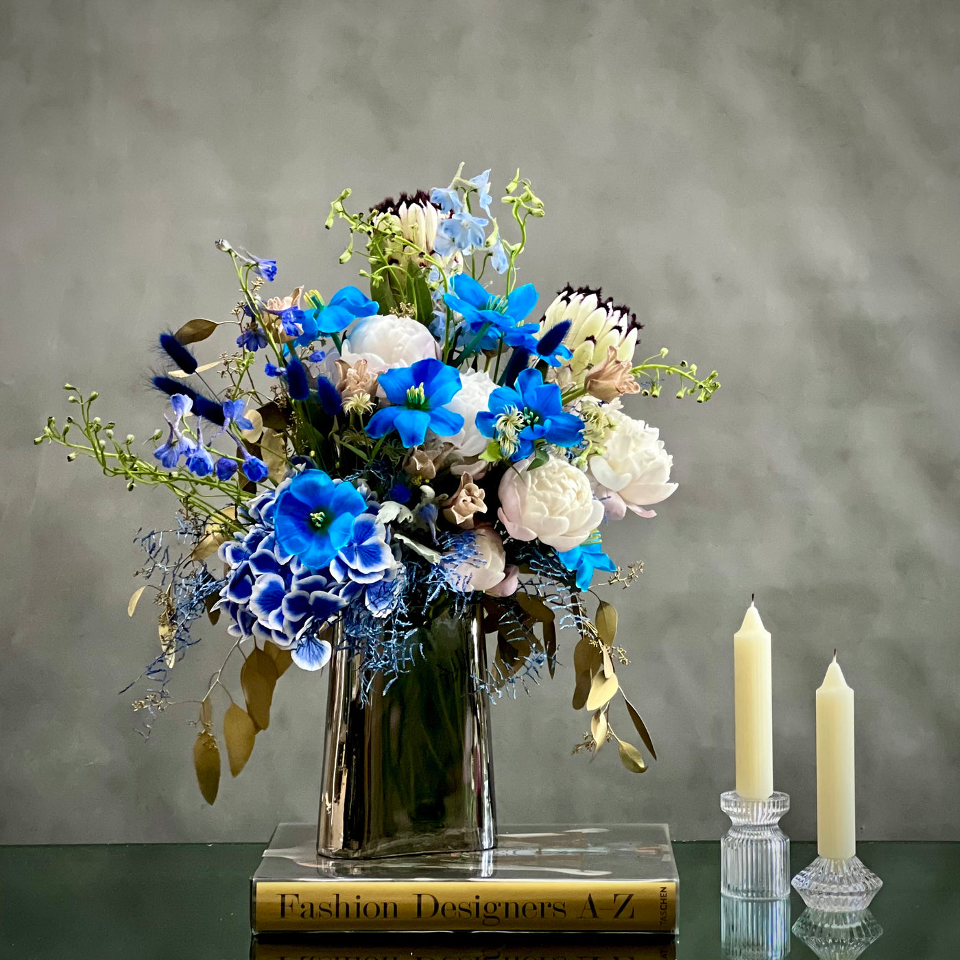 When your Monday's are feeling rather blue. Why not try this quiet little bouquet from  Beverly Hills Florist to bring a bit of serenity into your week with same day delivery service. This sure to never disappoint, these wonderful selections of blues tulips, white peonies, and white king protea are there to brighten even the gloomiest of days.