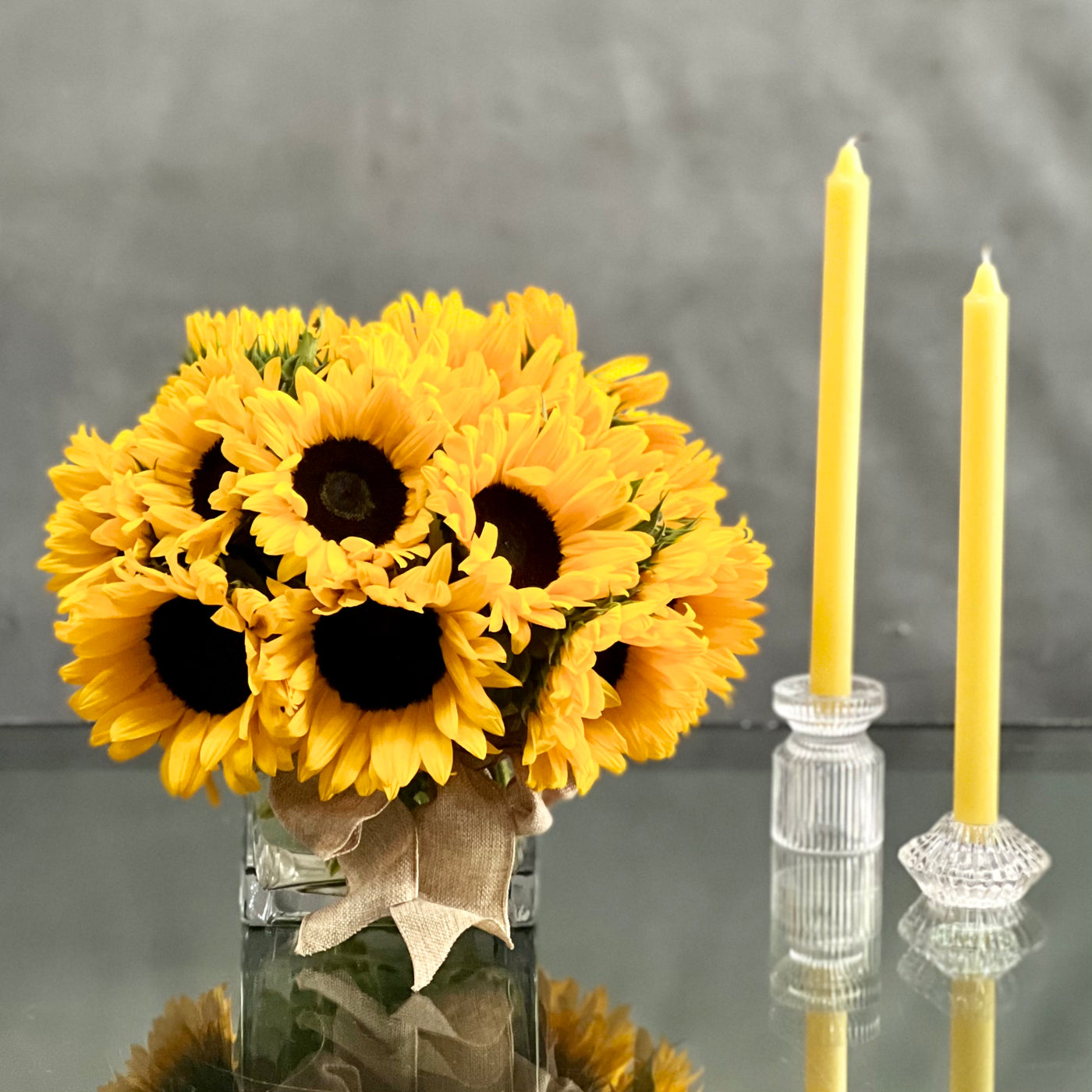 This sunny sunflowers is set in a 5X5 glass vase and tied with a beautiful bow by  Beverly Hills Florist is sure to put a smile on anyone's face on occasions like get well, thank you, just because.