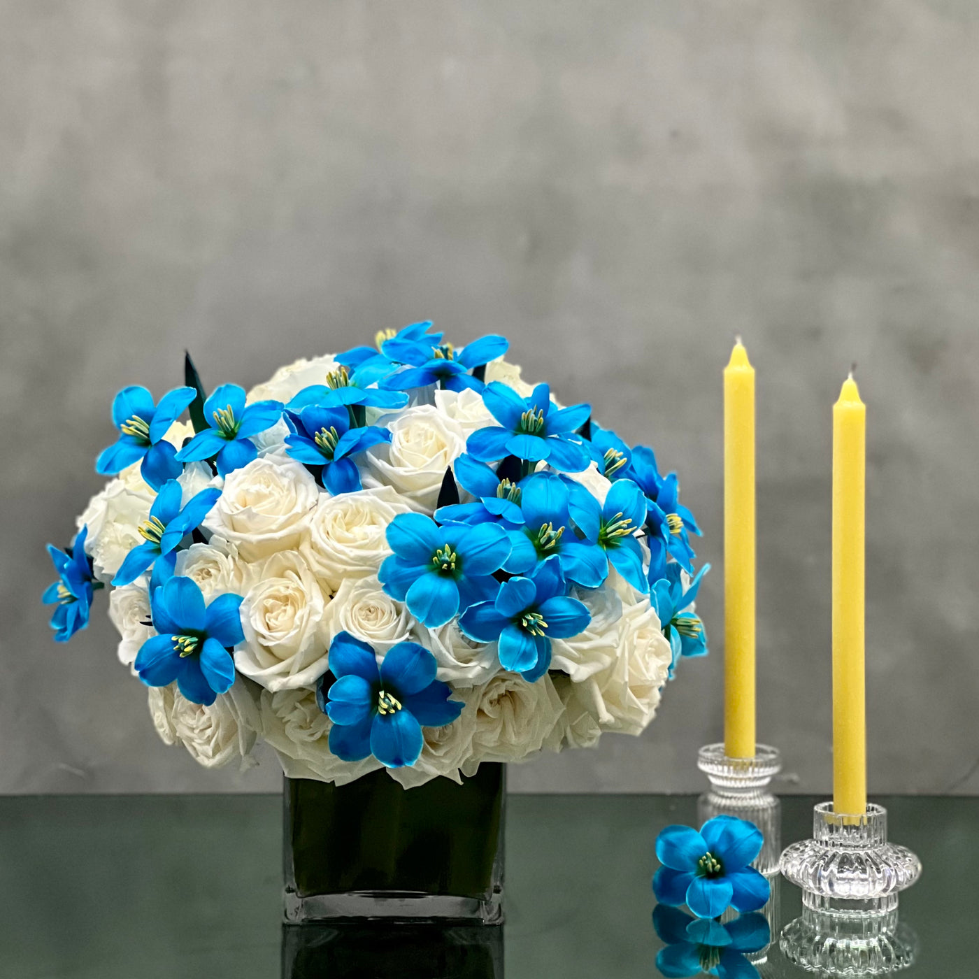 Our team at Beverly Hills Florist presents same day delivery for our Butterfly Kisses arrangement. Beautifully arranged in a glass vase are approximately 50 White Roses and 40 Blue Tulips placed in a 6x6 glass vase. Butterfly Kisses is the perfect floral piece that will brighten up wherever it is placed ! As pretty as it looks, our arrangement makes for a wonderful birthday gift, thank you & just because.