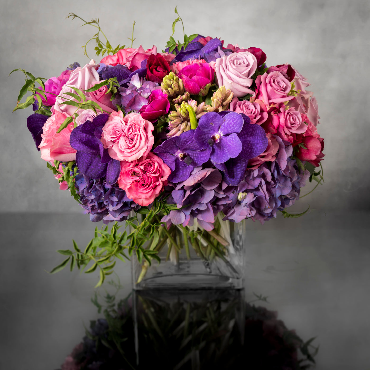 Aroma Therapy arrangement with Dutch orchids, garden roses, and hydrangeas in shades of blue, pink, and purple, available for same-day delivery by Beverly Hills Florist.