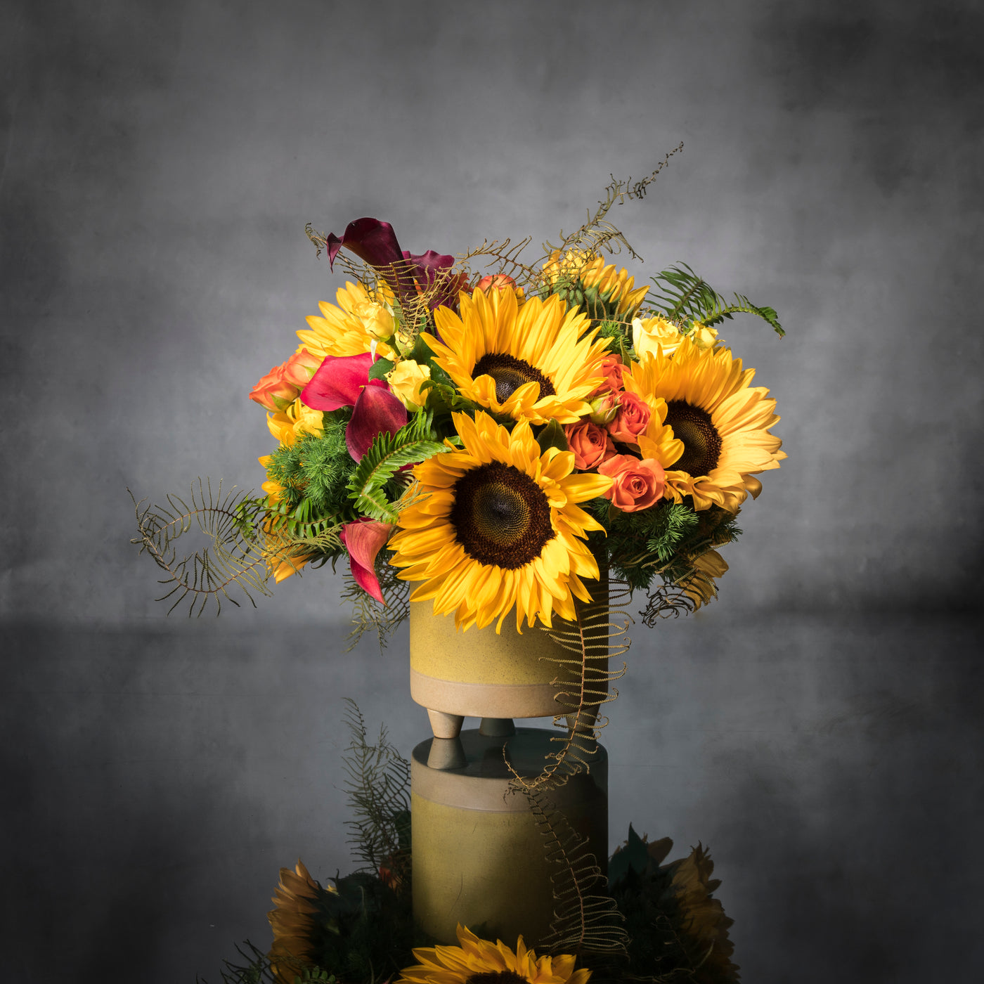 Beautiful Sunshine arrangement with sunflowers in a yellow ceramic-footed vase, available for same-day delivery by Beverly Hills Florist.