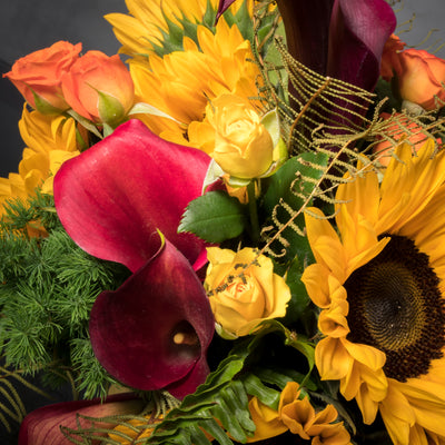 Beautiful Sunshine arrangement with sunflowers in a yellow ceramic-footed vase, available for same-day delivery by Beverly Hills Florist."