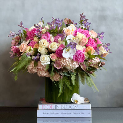 Blooming arrangement with peonies, roses, orchids, hydrangeas, and seasonal greens in a chic design, available for same-day delivery by Beverly Hills Florist.