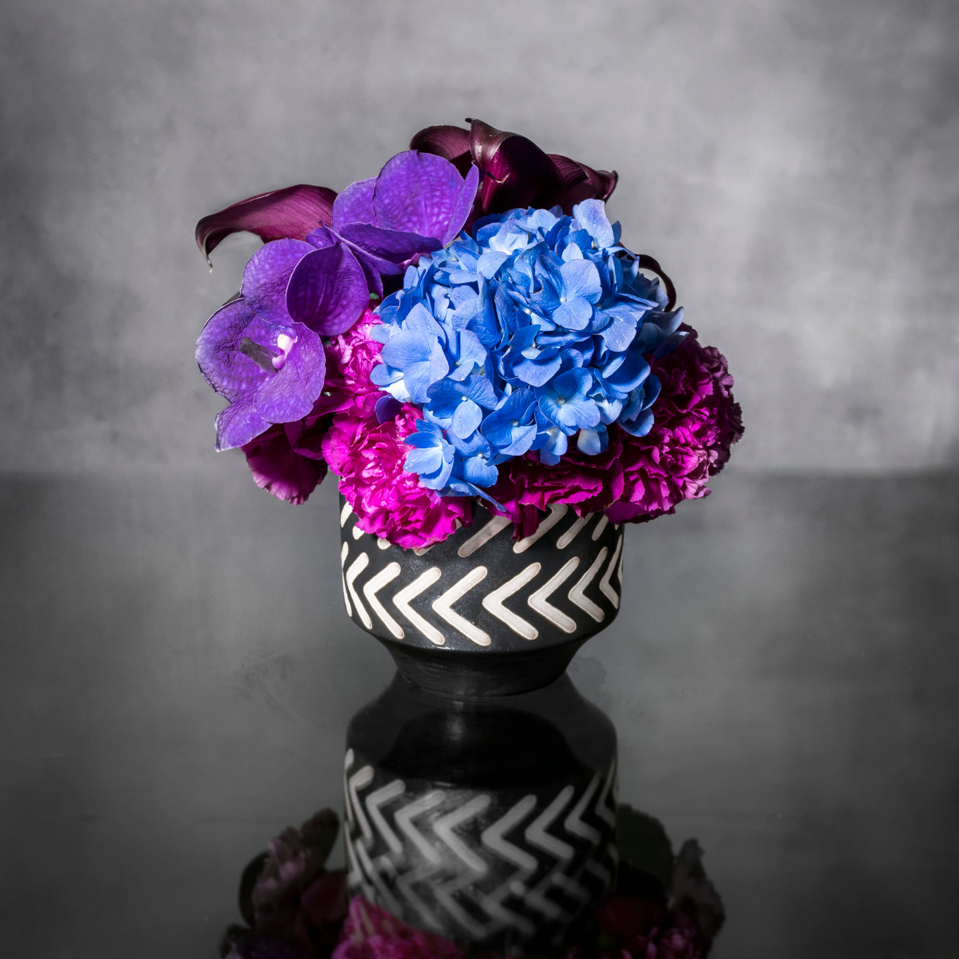 Blue Moonlight arrangement with blue, purple, and pink specialty flowers, available for same-day delivery by Beverly Hills Florist.