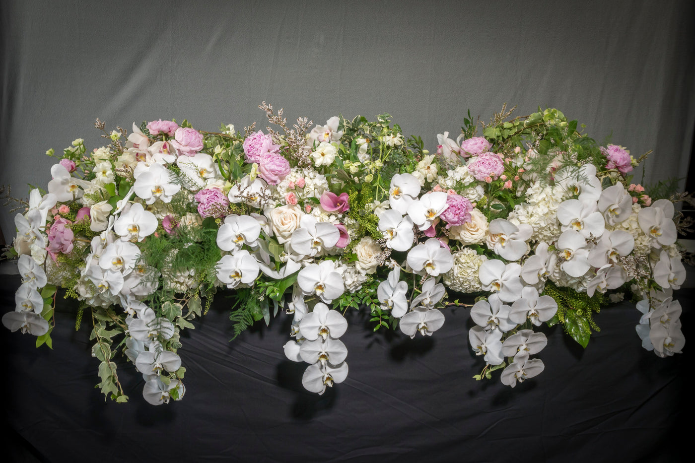 Casket Floral arrangement with peonies, garden roses, orchids, and white blooms, designed for funeral services, available for same-day delivery by Beverly Hills Florist.