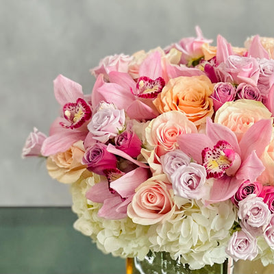 Elegant mixed bouquet of roses, orchids & hydrangeas in a mirrored gold vase