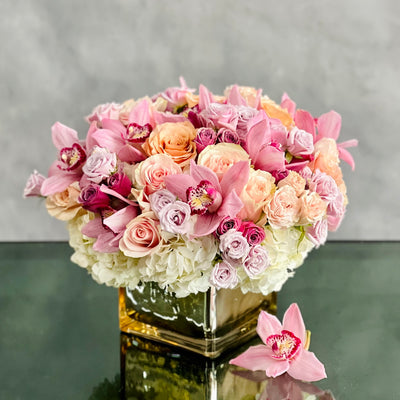 Elegant mixed bouquet of roses, orchids & hydrangeas in a mirrored gold vase