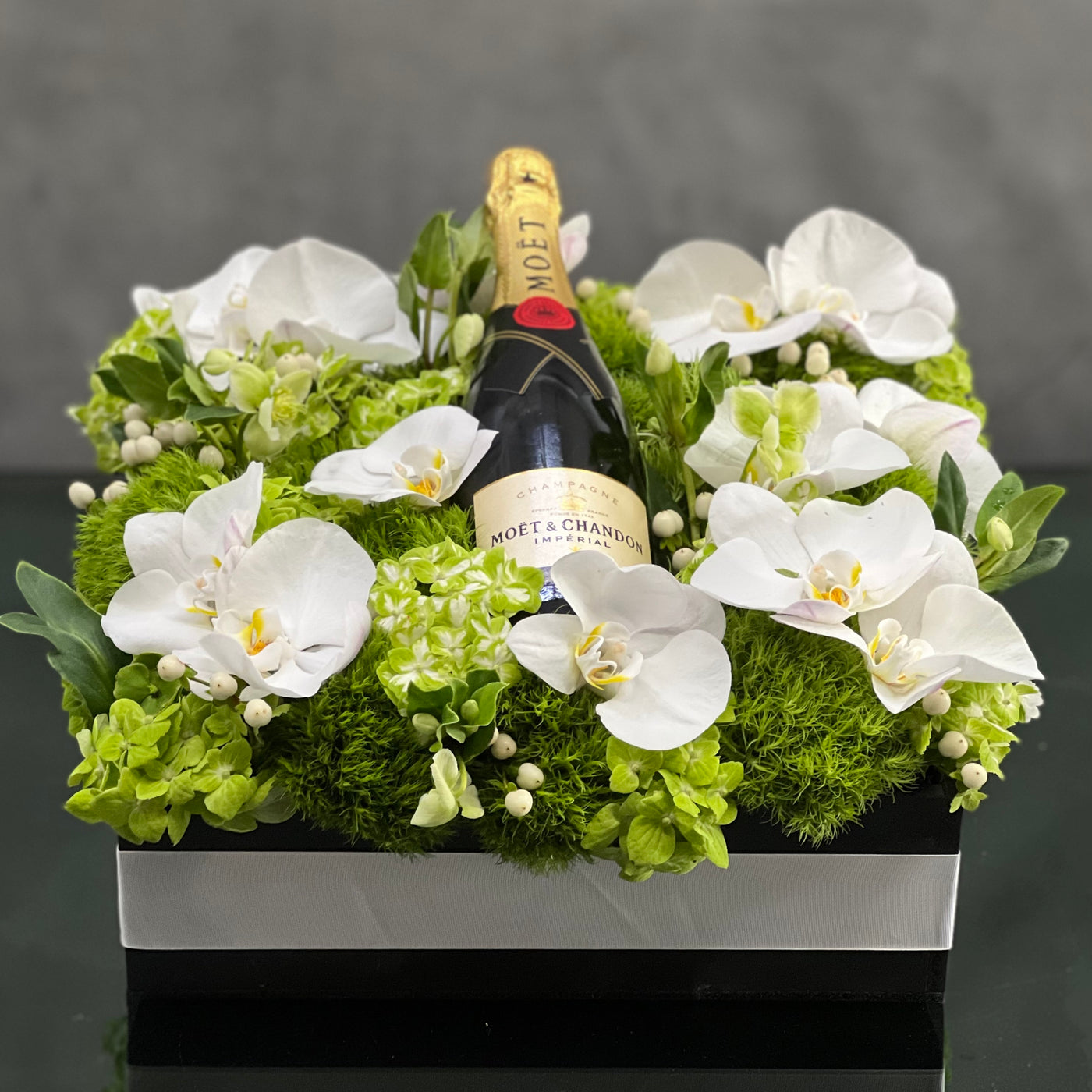 Beverly Hills Florist presents this luxury Moet floral box with orchids and other locally sourced flowers. 24 inch square box. for same day delivery !