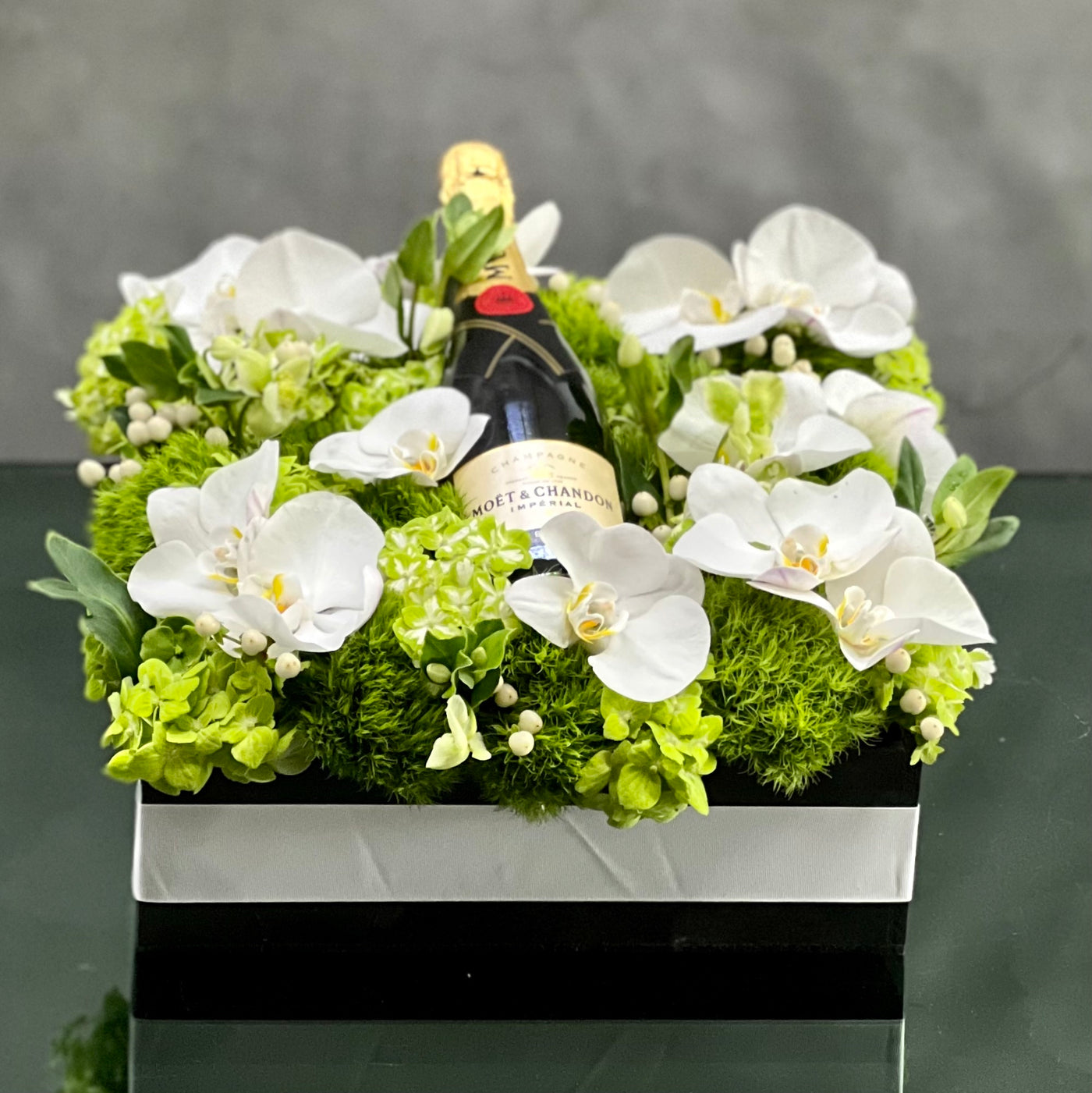 Beverly Hills Florist presents this luxury Moet floral box with orchids and other locally sourced flowers. 24 inch square box
