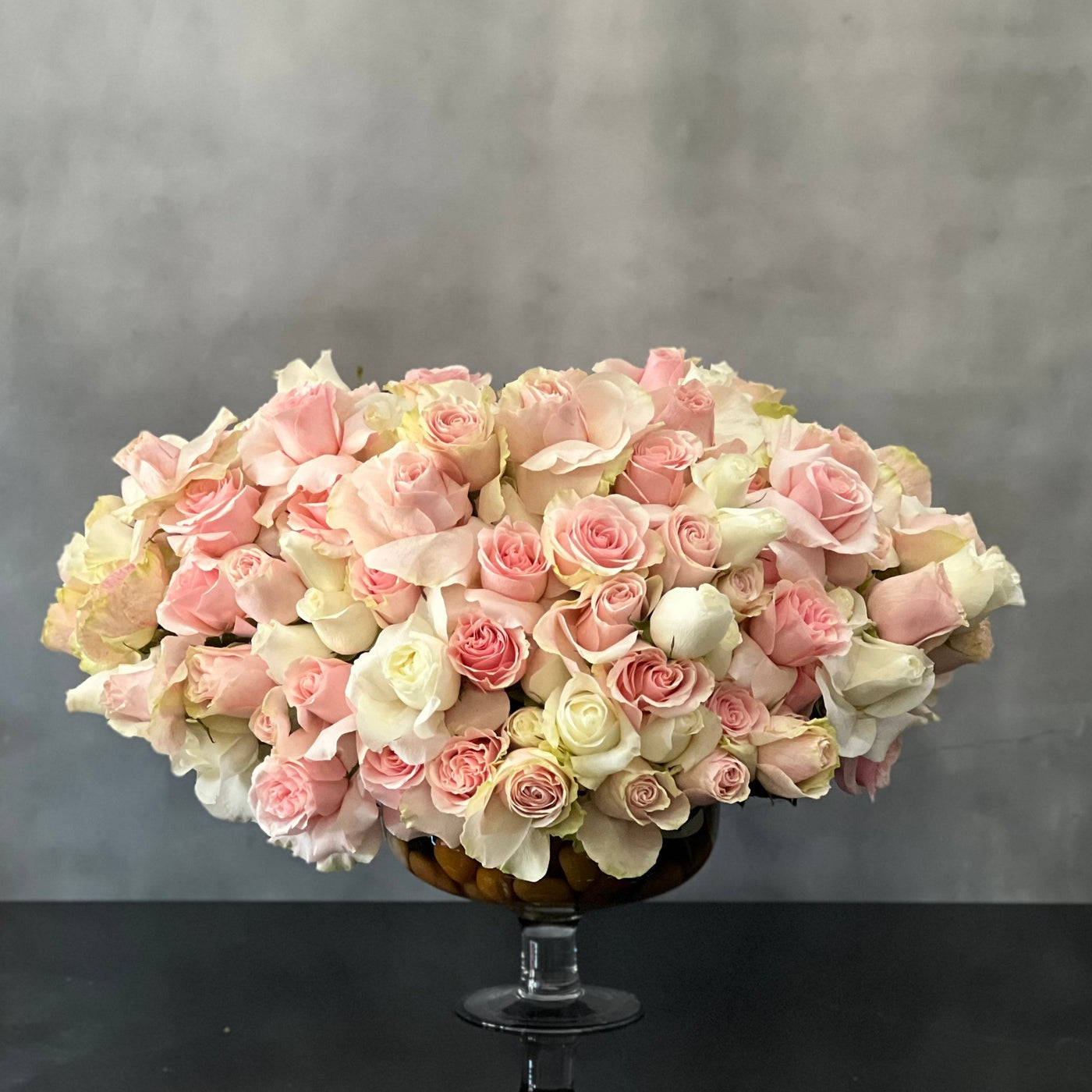 Designed to be the ultimate expression of your affection our team at Beverly Hills Florist can arrange our Passion in Pink for same day delivery. In our floral piece we have over 100 stems of Light Pink and white South American Roses are exquisitely arranged in a container. This is sure to leave an impression that's impossible to forget! A notion of sincerity making it wonderful for love and romance, thinking of you, congratulations, welcomes and more ! 