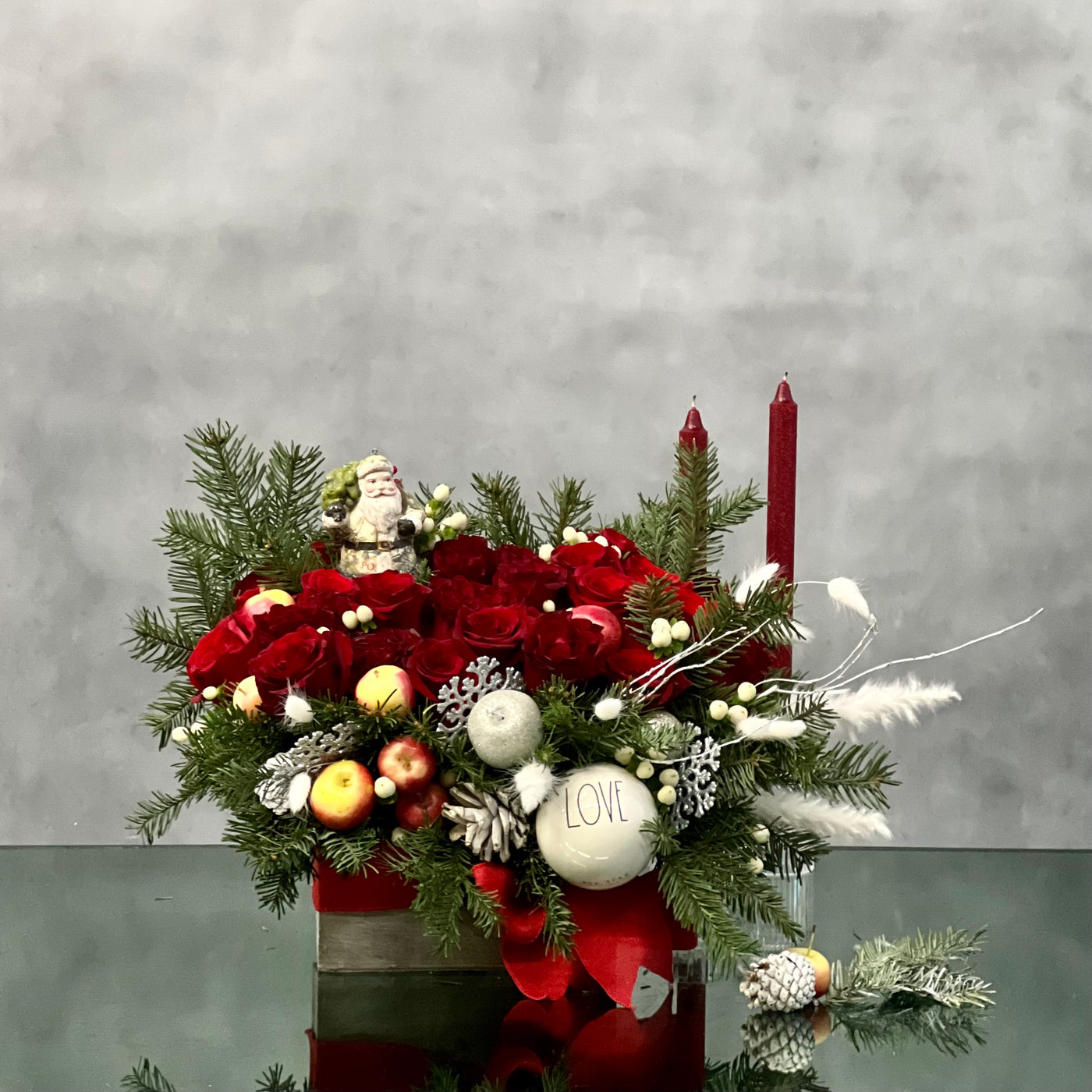 Red Holiday Box featuring over 36 red roses, holiday greens, berries, and festive ornaments, with dimensions 18 inches wide and 9 inches tall, available for same-day delivery in Beverly Hills.