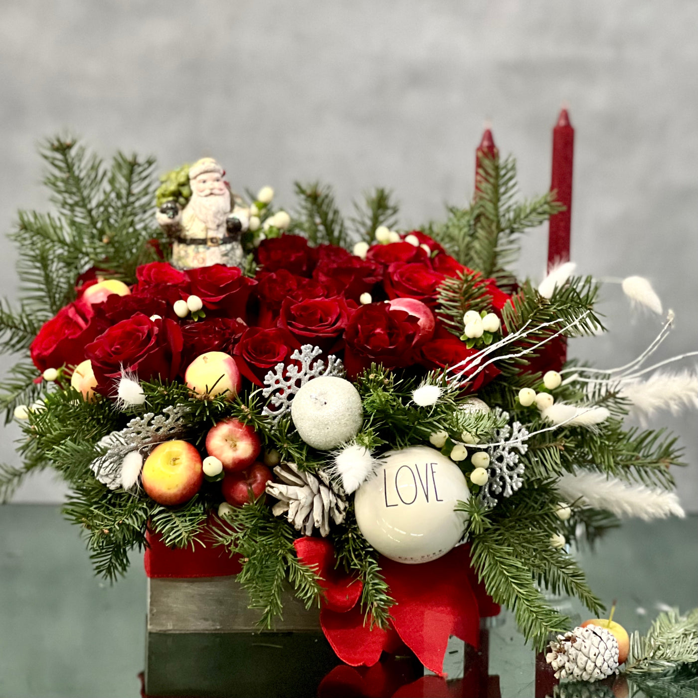 Red Holiday Box featuring over 36 red roses, holiday greens, berries, and festive ornaments, with dimensions 18 inches wide and 9 inches tall, available for same-day delivery in Beverly Hills.