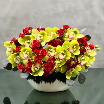 Beverly Hills Florist presents same day delivery for our magnificent arrangement! Our team created Florence with 32 Cymbidium Green Orchids, 14 Red Roses, 20 Spray Roses & Eucalyptus. All arranged within a ceramic black and white vase. Florence would make a perfect floral piece for Birthday, Thank you, Love and Romance, Kindness, Thinking of you & Just Because!