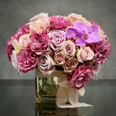 Preciously Pink our Vintage Pinks by our team can be sent out for same day delivery! This delightful design from Beverly Hills Florist features an array of 50 pink Roses with 2 purple orchids all come together in perfect color harmony in a gold mirrored vase. A wonderful way to say I love you ! Making this arrangement wonderful for Birthdays, love and romance and Thinking of you ! 